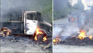 One of the Tata Sumo burnt by bandh enforcers and bandh being enforced on NH-37