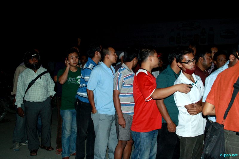 Customers queuing up at a  petrol pump at night-time :: 12 July 2012